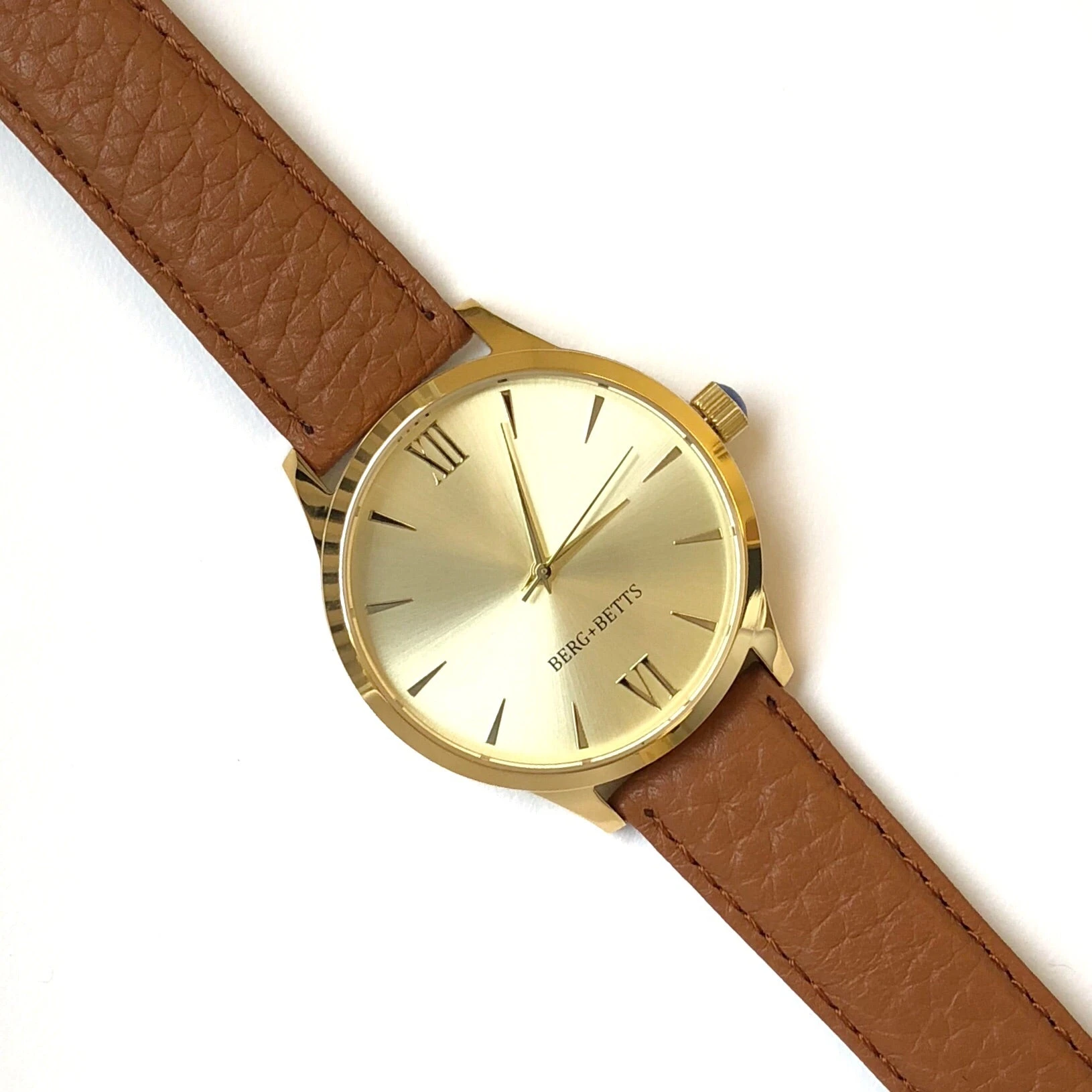 Minimalistic round gold watch with camel strap made from recycled leather