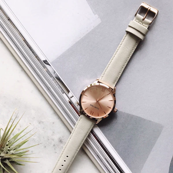 Minimalistic round gold watch with ivory strap made from recycled leather
